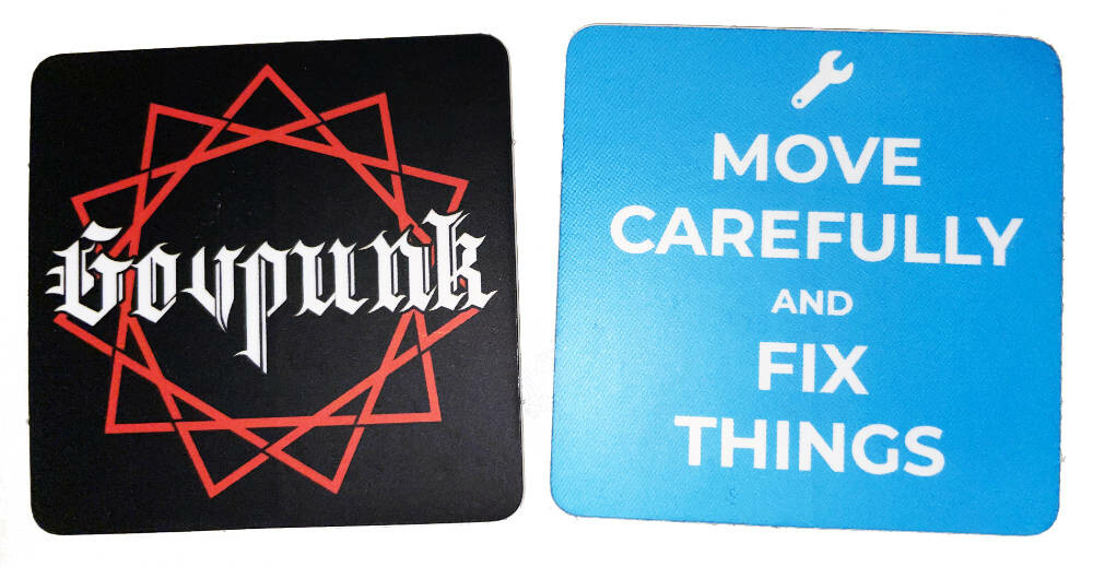 Two different sticker designs - one says "Govpunk" and the other says "Move Carefully and Fix Things"